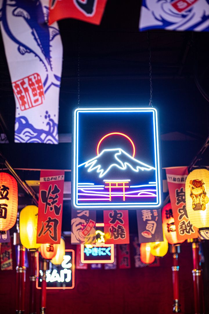 Neon Mount Fuji sign and lanterns inside Curry Mee
